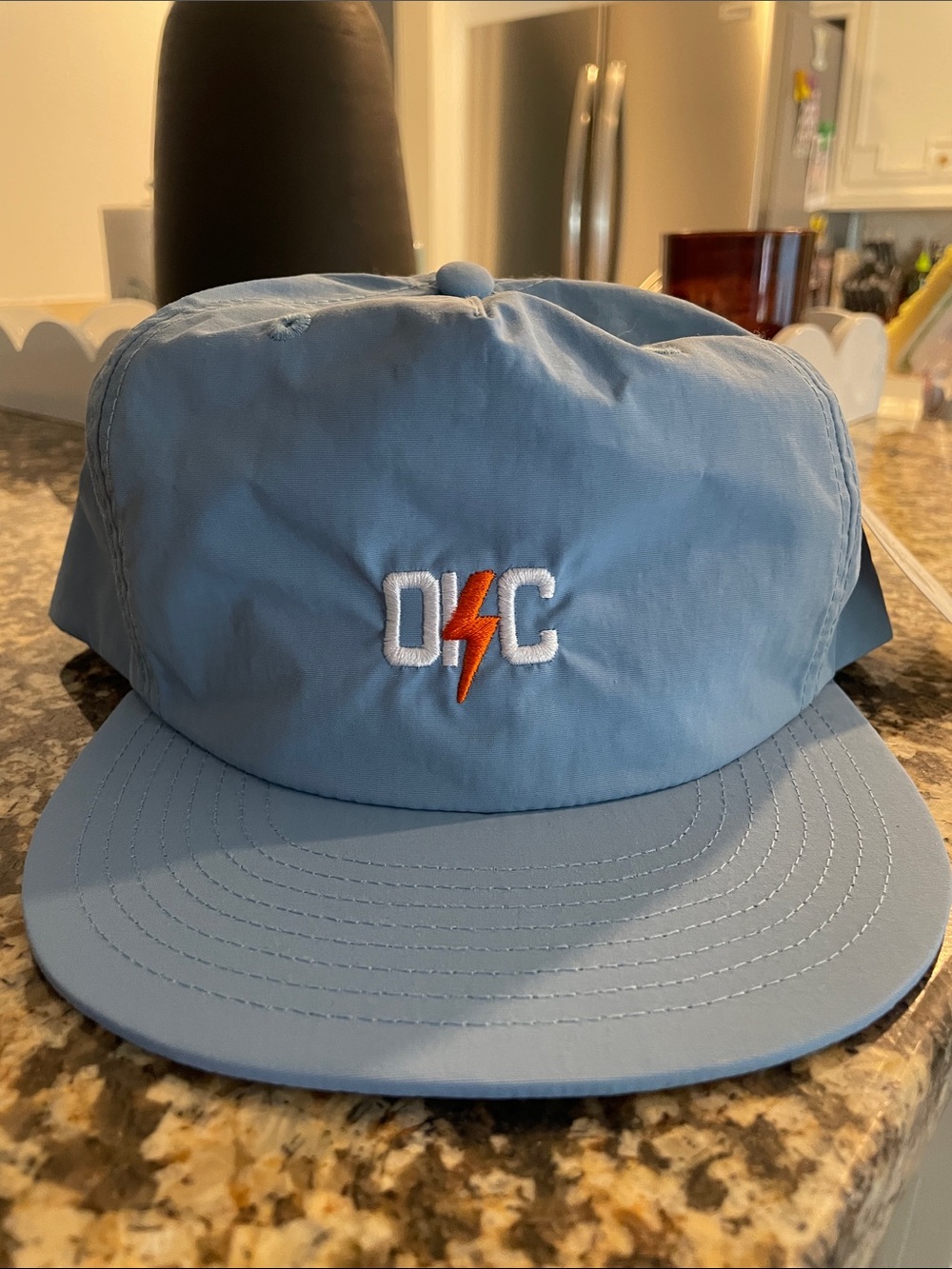 Light Blue Cap with White and Orange Lightning Logo